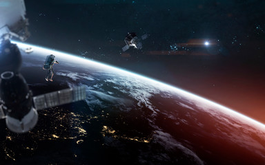 Look on our planet from orbit and astronauts at the spacewalk. Elements of this image furnished by...
