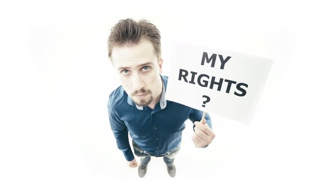 Man holding sign My Rights 4K. Extreme wide shot top view of person head in focus while pull up a sign. White background.