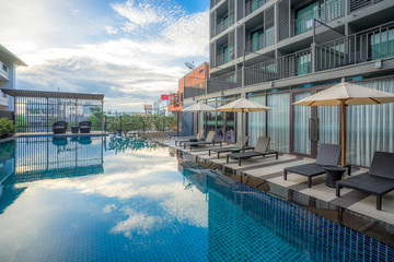 Swimming pool with umbrellas and beach chairs.