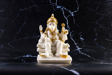 Ganesh marble carved on a black background
