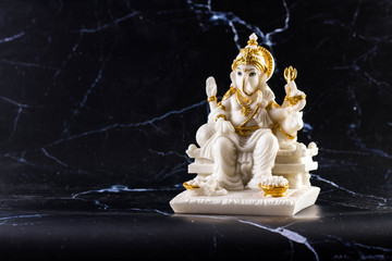 Ganesh marble carved on a black background