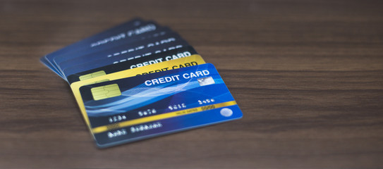 Many credit cards are placed on the wooden floor.