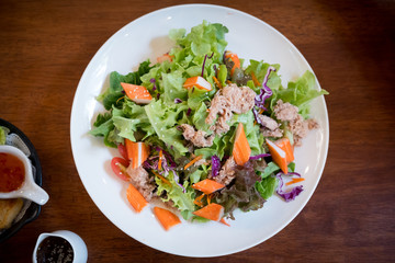 Healthy bowl of homemade salad with fresh vegetables, crab stick and tuna