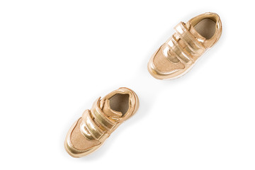 flat lay. the gold children's sports shoes isolated on a white background