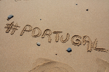 hashtag written by hand in the sand