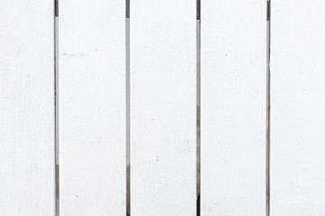 closeup texture of wooden white fence or table with space between plank.
