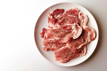 Fresh raw seasoned pork on plate 