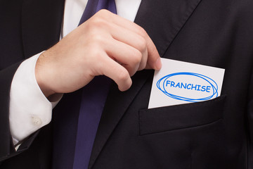 Business, technology, internet and networking concept. Young entrepreneur showing keyword: Franchise