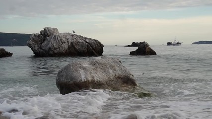 The waves of the Adriatic Sea are crushing on the stones on the beach