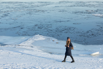 woman walking on the frozen beach