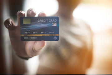 Hands holding plastic credit card for pay. This is Shopping concept