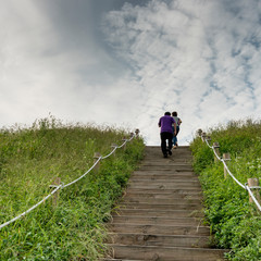 Obraz premium Two people running up steps in park, Seoul, South Korea