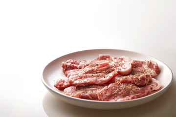Fresh raw seasoned pork on plate 