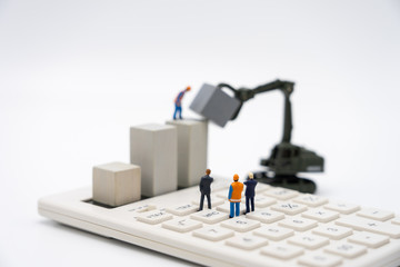 Miniature people  businessmen standing Investment Analysis Or investment. The concept of being the number one business in the world stands at its peak.