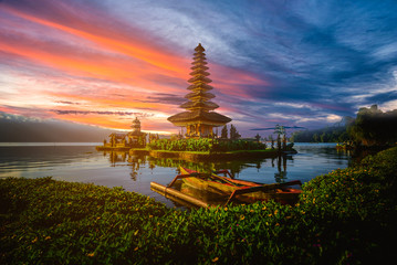 Pura Ulun Danu Bratan, Hindu temple with boat on Bratan lake landscape at sunset in Bali, Indonesia.