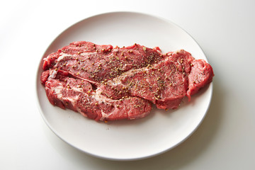 Fresh raw seasoned beef on plate