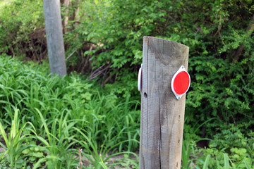 Reflector light on wooden post on rural country road 