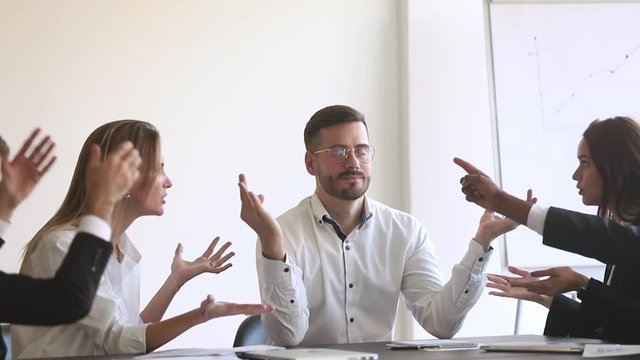 Mindful businessman meditate at meeting ignore colleagues argue at workplace