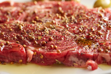 Fresh raw seasoned beef with olive oil