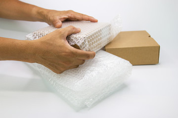 hand of man hold bubble wrap, for protection parcel product cracked or insurance During transit