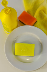 Bottle of dishwashing liquid and stack of utensils