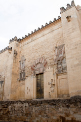 wall and tower of cordoba mosque from down to the sky in Spain