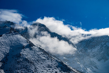 snow on the mountain and clouds