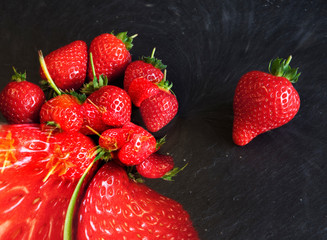 single strawberry separate from an abstract group symbol for Standing Out From The Crowd
