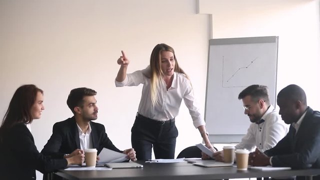 Angry female boss shouting at meeting firing stressed african employee