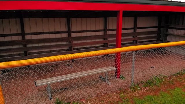 bright red and yellow dugout on the Little league baseball field