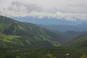 Fototapeta premium Hiking with a tent through Petros to Hoverla, Lake Nesamovite, Mount Pop Ivan Observatory.