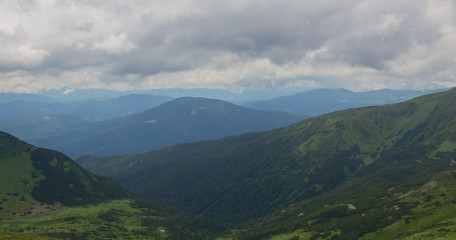 Fototapeta premium Hiking with a tent through Petros to Hoverla, Lake Nesamovite, Mount Pop Ivan Observatory.