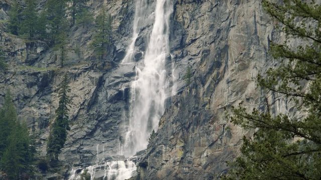 Stunning Waterfall Pan Up Slow Motion Over Rock Cliffs