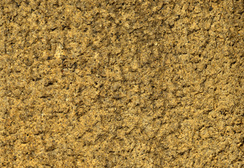 Yellow stone wall with rough surface as background