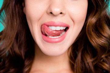 Cropped close-up view portrait of nice cheeky healthy perfect white cheerful cheery wavy-haired girl licking lip isolated over bright vivid shine blue background