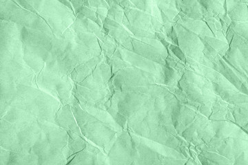 Trendy neo mint colored textured background. Crumpled craft paper. Flat lay. Color of the year 2020