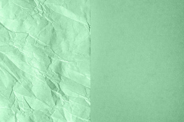 Crumpled and plain paper sheets divided in center creating line partition. Trendy neo mint colored...