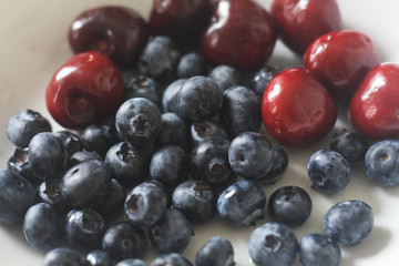 Blueberries and Cherry in white plate