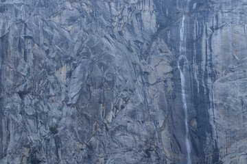 Close up of granite cliff with waterfall in Yosemite National Park