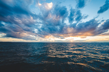 Sunset sea view with dramatic sky and colorful clouds