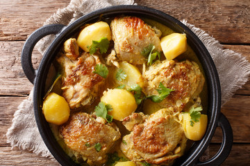 Popular spicy chicken coconut curry with potatoes close-up in a pan. horizontal top view