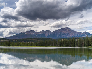 Fototapeta na wymiar Reflection of mountains in lake, Icefields Parkway, Jasper, Alberta, Canada