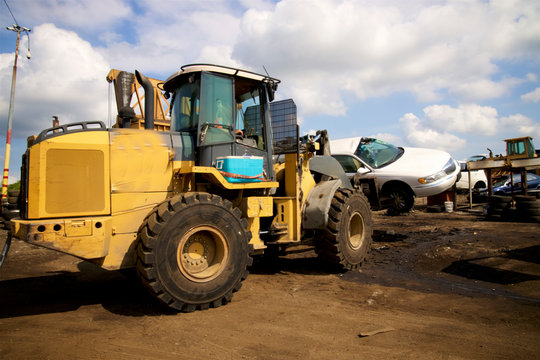 smashing cars at the junkyard car crushing - Powered by Adobe