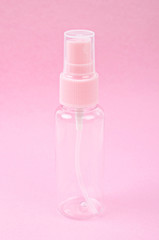 Clear pink plastic bottle spray.