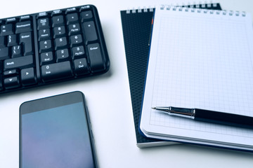 Office desk table with computer keyboard and supplies. On white background. Copy space. Mock up.