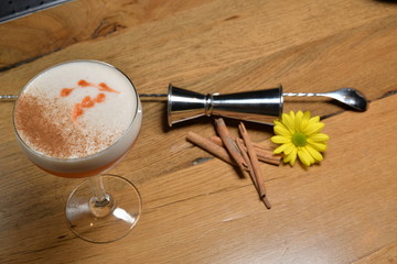 cup of coctail and book on wooden table