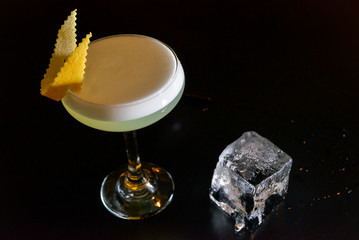 glass of water with lemon on black background