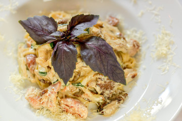 seafood pasta decorated with basil leaf