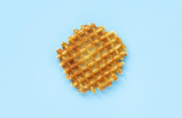 Belgian waffles on a blue background, top view, flat lay, minimalistic.