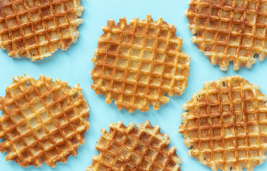 Belgian waffles on a blue background, top view, flat lay, minimalistic.